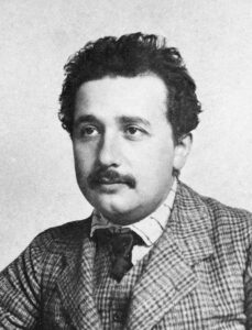 Albert Einstein – creator of our relativistic world – in 1905 by Lucien Chavan, a friend of when both were living in Berne. Public Domain.
